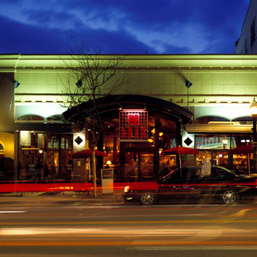 Brix the Restaurant's illuminated sign glowing brightly against the night sky on iconic Sherman Avenue in Coeur d'Alene, ID, highlighting the modern design by Ginno Construction Co.